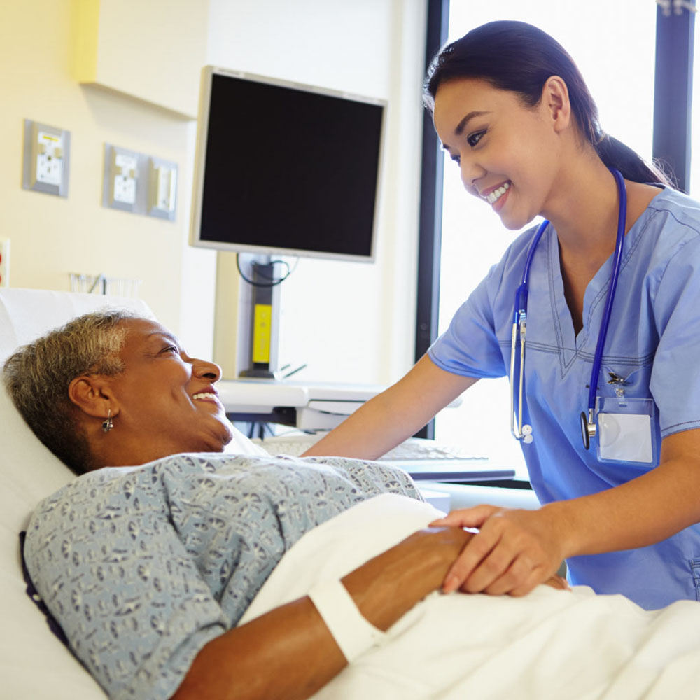 additional care Nurse Talking To Senior Woman In Hospital Room